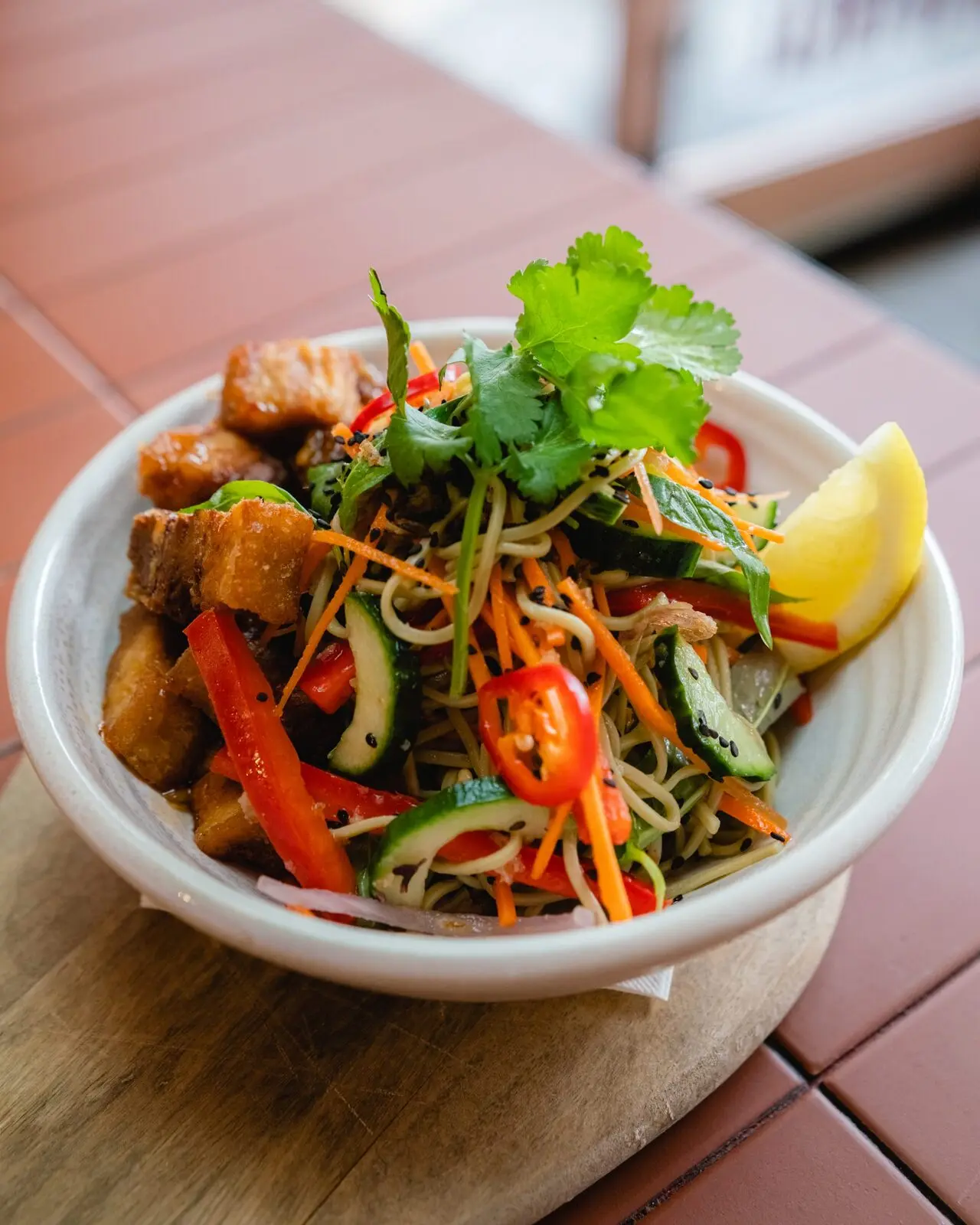 Sticky pork and soba noodle salad with cucumber, carrot, chilli and coriander